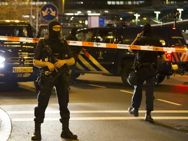 Pihak keamanan Belanda berjaga di area Bandara Internasional Schiphol, Amsterdam, yang ditutup menyusul ancaman bom, Selasa (12/4).  Pihak kepolisian menangkap seorang pria dengan perilaku mencurigakan terkait ancaman bom. (Michel van Bergen/ANP/AFP)