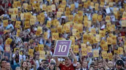 Francesco Totti mengangkat nomor seragam yang dipakainya, usai pertandingan antara AS Roma dan Genoa di Stadion Olimpico, Minggu (28/5). Setelah 25 tahun membela AS Roma, Totti mengakhiri kiprahnya di sepak bola profesional (AP Photo/Alessandra Tarantino)