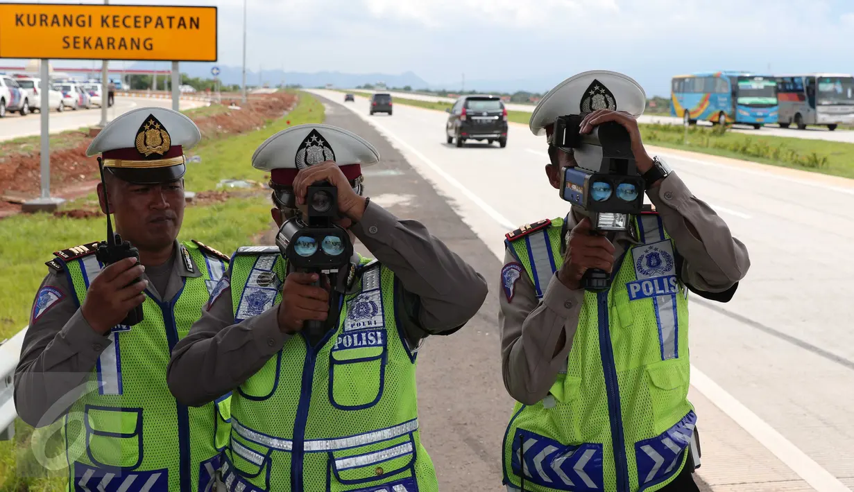 Polisi gunakan alat pendeteksi laju kendaraan di ruas tol Cikampek-Palimanan KM.165, Majalengka, (14/12). Polda Jabar bekerjasama dengan PT Lintas Marga Sedaya (LMS) melakukan berbagai langkah penegakan hukum. (Liputan6.com/Angga Yuniar)