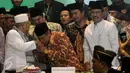 Ketua PBNU terpilih, KH Said Aqil Siradj (tengah)mencium tangan Rois Am PBNU terpilih, KH Ma'ruf Amin (kiri) saat penutupan Muktamar NU di Jombang, Jawa Timur, Kamis (6/8/2015). (Liputan6.com/Johan Tallo)