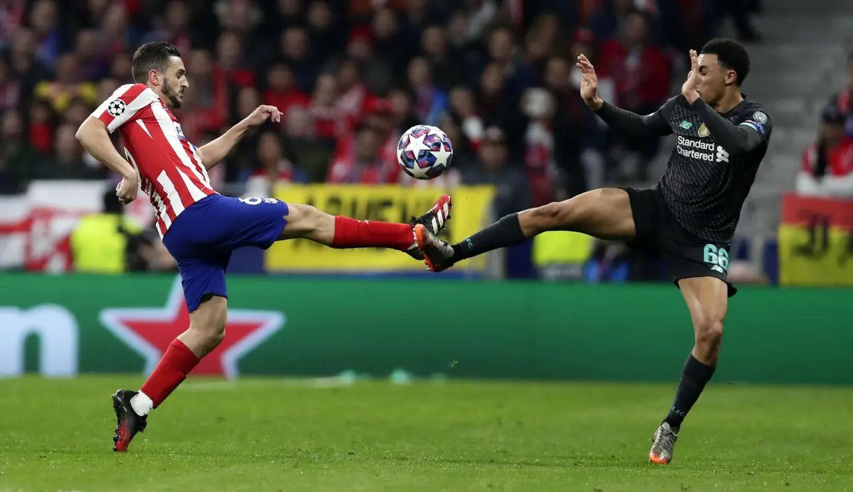 Gelandang Atletico Madrid, Koke berebut bola dengan bek Liverpool, Trent Alexander-Arnold Niguez  pada pertandingan leg pertama babak 16 Liga Champions di stadion Wanda Metropolitano di Madrid, Spanyol, Selasa (18/2/2020). Atletico Madrid menang tipis atas Liverpool 1-0. (AP Photo/Manu Fernandez)