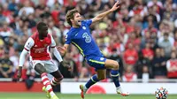 Pemain Arsenal Nicolas Pepe (kiri) melakukan pelanggaran terhadap pemain Chelsea Marcos Alonso (kanan) pada pertandingan Liga Inggris di Emirates Stadium, London, Inggris, 22 Agustus 2021. Chelsea menang 2-0. (JUSTIN TALLIS/AFP)