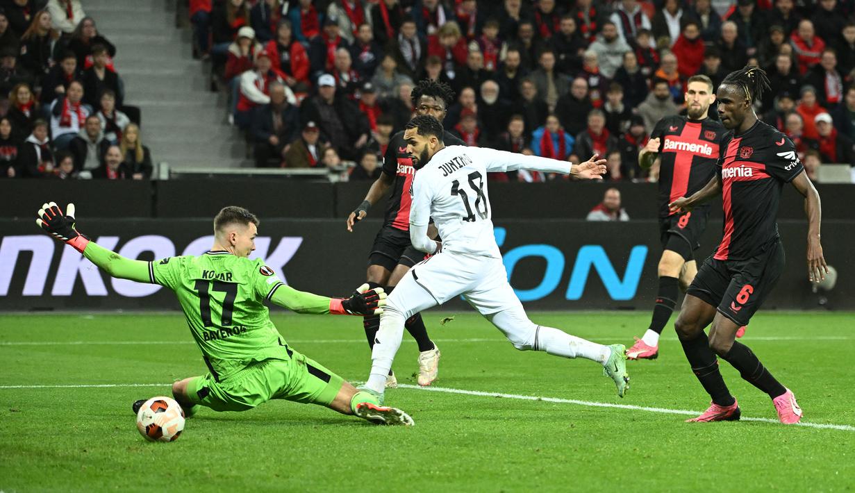 Kiper Bayer Leverkusen, Matej Kovar (kiri) gagal menghalau bola tendangan dari pemain Qarabag, Juninho saat laga leg kedua 16 besar Liga Europa 2023/2024 di BayArena, Leverkusen, Jerman, Jumat (15/03/2024) dini hari WIB. (AFP/Ina Fassbender)