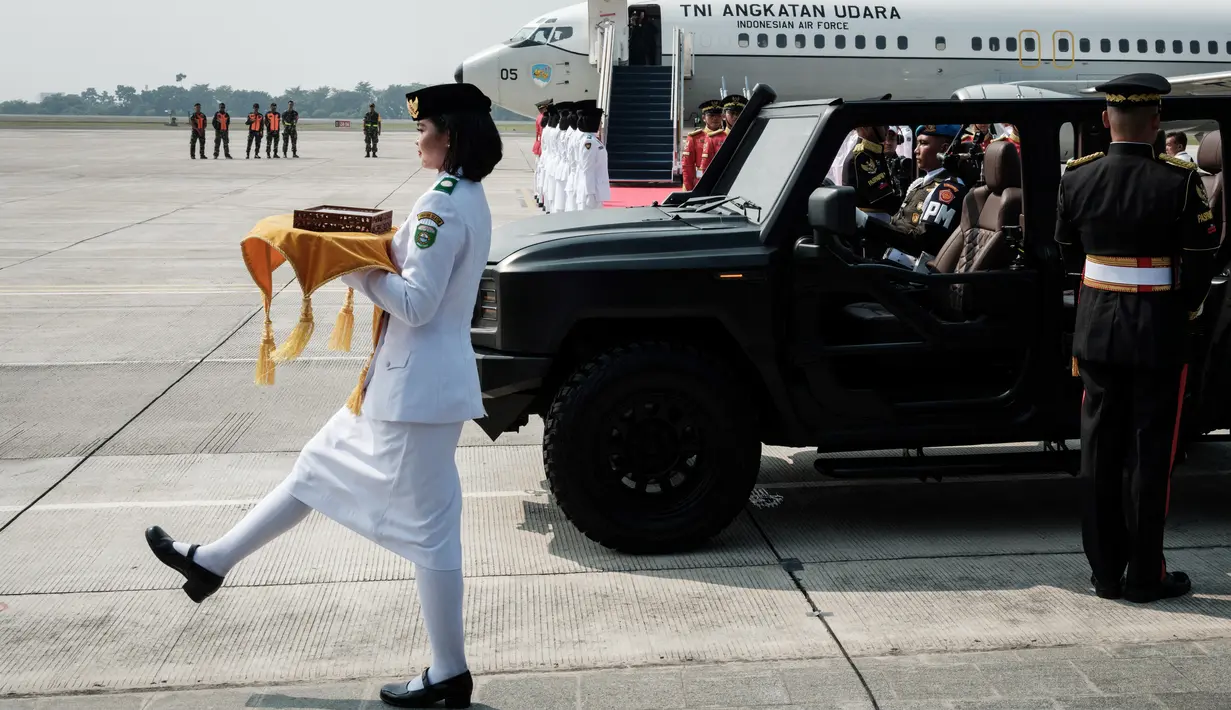Tim Purna Paskibraka DKI Jakarta 2023 yang terdiri dari 22 orang bersama enam personel Paspampres menyambut kedatangan rombongan kirab di Bandara Halim Perdanakusuma. (Yasuyoshi CHIBA / AFP)