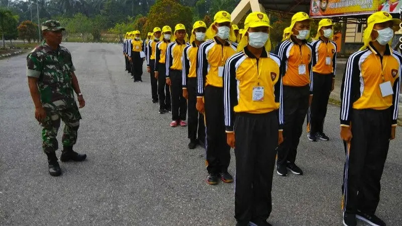 Calon anggota Paskibra Pelalawan latihan memakai masker karena daerah itu diselimuti kabut asap kebakaran lahan.