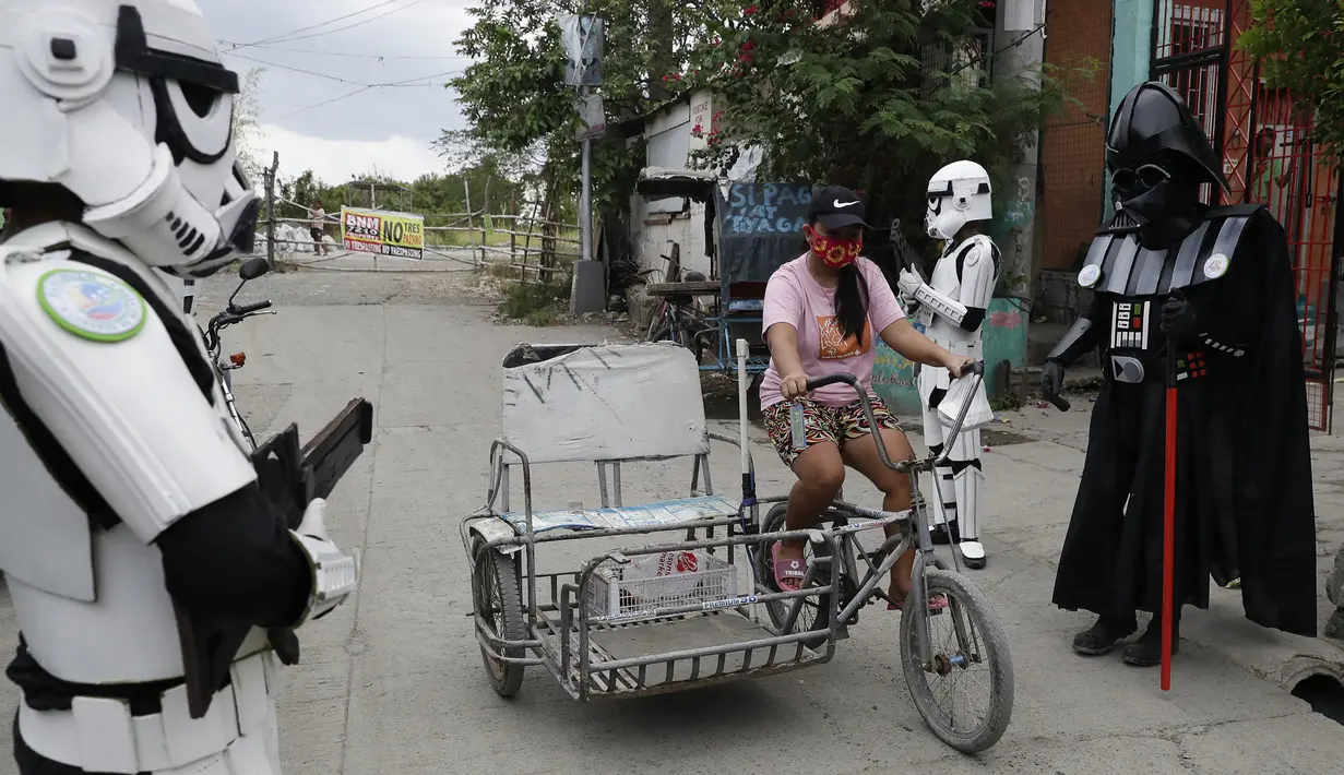 Anggota kelompok pemuda dalam kostum Star Wars menghibur warga di Malabon, Metro Manila, Filipina, Kamis (30/4/2020). Kelompok pemuda berkostum Star Wars menghibur warga selama karantina berkelanjutan akibat COVID-19 serta mengingatkan mereka agar tetap di rumah. (AP Photo/Aaron Favila)