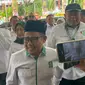 Ketua Umum Partai Kebangkitan Bangsa (PKB) Muhaimin Iskandar atau Cak Imin tiba di acara pembukaan musyawarah kerja nasional (Mukernas) di hari lahir (Harlah) PKB ke-26, Jakarta Convention Center (JCC), Senayan, Jakarta, Selasa (23/7/2024) (Liputan6.com/Winda Nelfira)