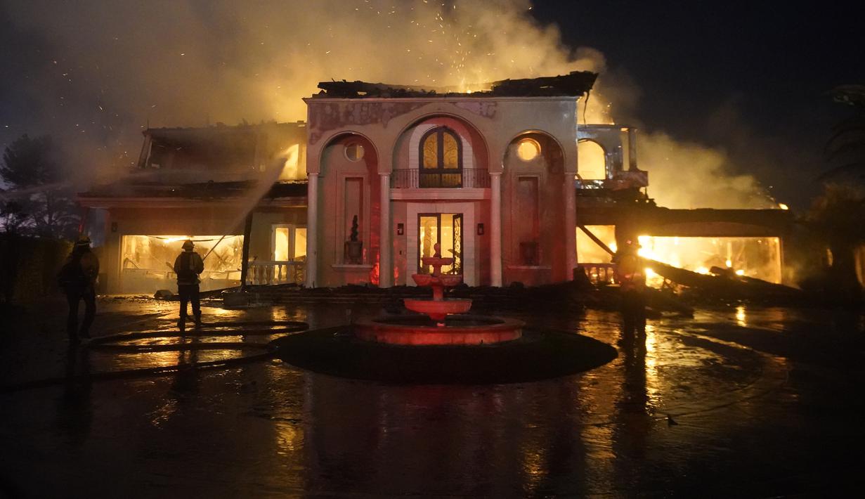 Petugas pemadam kebakaran bekerja untuk memadamkan bangunan yang terbakar saat kebakaran hutan di Laguna Niguel, California, Amerika Serikat, 11 Mei 2022. (AP Photo/Marcio J. Sanchez)