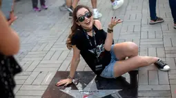 Penonton wanita berselfie di samping bintang Metallica saat menghadiri Rock in Rio Festival di Olympic Park, Rio de Janeiro, Brazil, (21/9). Festival ini berlangsung  selama tujuh hari 15-17 September dan 21-24. (AFP Photo/Mauro Pimentel)
