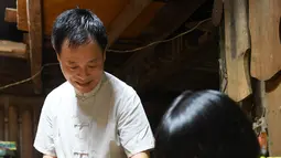 Ma Yuesi (kiri) membuat Guqin, alat musik tradisional China, di kediamannya di Desa Yalan, Distrik Yuhang, Hangzhou, Provinsi Zhejiang, China pada 30 Juni 2020. Selama bertahun-tahun, sebagai pewaris warisan budaya takbenda, Ma tak pernah berhenti meningkatkan keterampilannya. (Xinhua/Weng Xinyang)