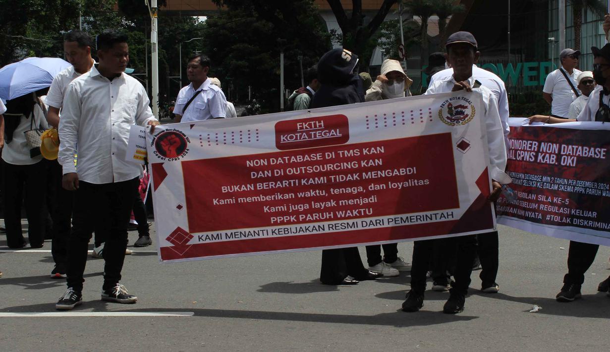Mereka juga menuntut agar dapat diakomodir menjadi Pegawai Pemerintah dengan Perjanjian Kerja (PPPK) Paruh Waktu, sebagaimana dijanjikan sebelumnya, meskipun tidak masuk dalam database Badan Kepegawaian Negara (BKN). Tampak dalam foto, massa dari Aliansi Honorer Non Database BKN Gagal Calon Pegawai Negeri Sipil (CPNS) Indonesia saat menggelar Aksi Damai Jilid 2 Nasional di kawasan Silang Selatan Monumen Nasional, Jakarta Pusat, pada Senin (17/11/2025). (merdeka.com/magang/Rendi Saputra)