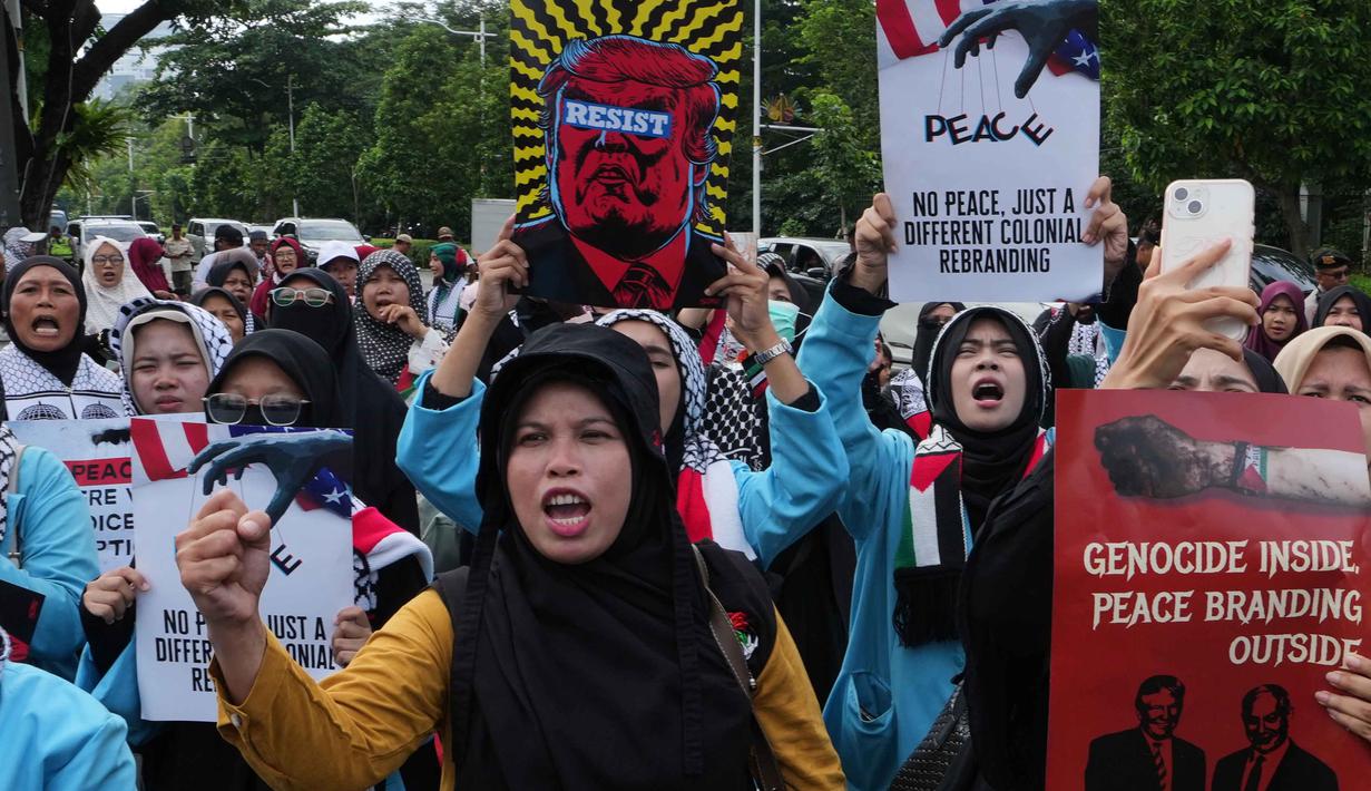 Mereka memprotes keterlibatan Indonesia dalam Board of Peace (BoP), sebuah badan internasional untuk rekonstruksi pascaperang di Gaza yang diusulkan oleh Presiden AS, Donald Trump. Tampak dalam foto, aktivis Muslim mengangkat poster dan meneriakkan slogan-slogan selama unjuk rasa dukungan untuk warga Palestina di Gaza, di depan Kedutaan Besar Amerika Serikat, Jakarta, Jumat 13 Februari 2026. (AP Photo/Achmad Ibrahim)