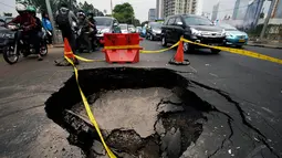 Jalan ambles selebar lebih dari 2 meter persegi itu mengejutkan pengguna jalan, Jakarta. Foto diambil pada Kamis (6/11/2014). (Liputan6.com/Johan Tallo)   