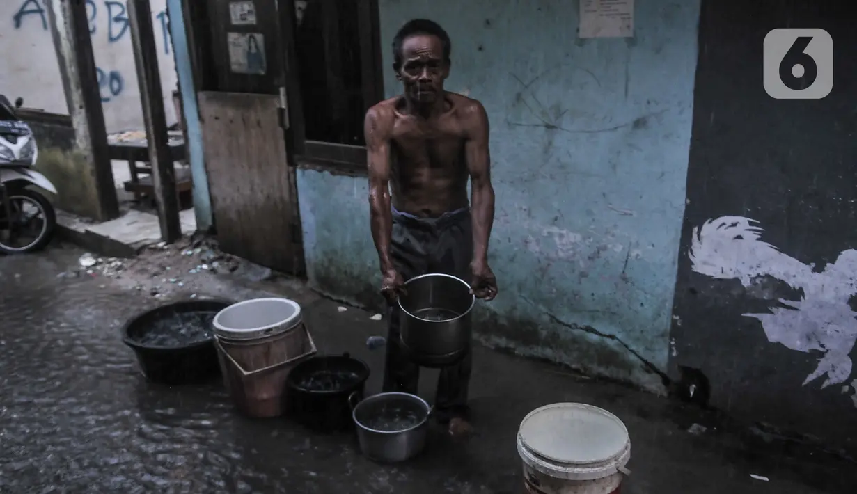 Warga menunjukkan wadah berisi air hujan yang akan digunakan untuk keperluan MCK di Kampung Bayam, Kelurahan Papanggo, Tanjung Priok, Jakarta, Rabu (21/10/2020). (merdeka.com/Iqbal S. Nugroho)