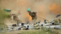 Tentara Armenia menembakkan meriam ke arah Azerbaijan di Republik Nagorno-Karabakh, Azerbaijan, Selasa (29/9/2020). Pasukan Armenia dan Azerbaijan saling serang saat memperebutkan Nagorno-Karabakh yang memproklamirkan diri. (Sipan Gyulumyan/Armenian Defense Ministry Press Service/PAN Photo via AP)