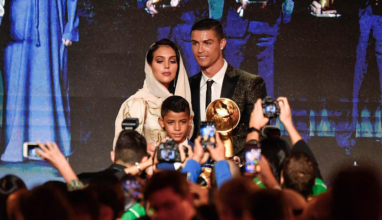 Georgina Rodriguez foto bersama dengan kekasihnya Cristiano Ronaldo dan putranya Cristiano Jr diatas panggung selama Dubai Globe Soccer Awards ke-10 di Dubai (3/1). (AFP Photo/Fabio Ferrari)