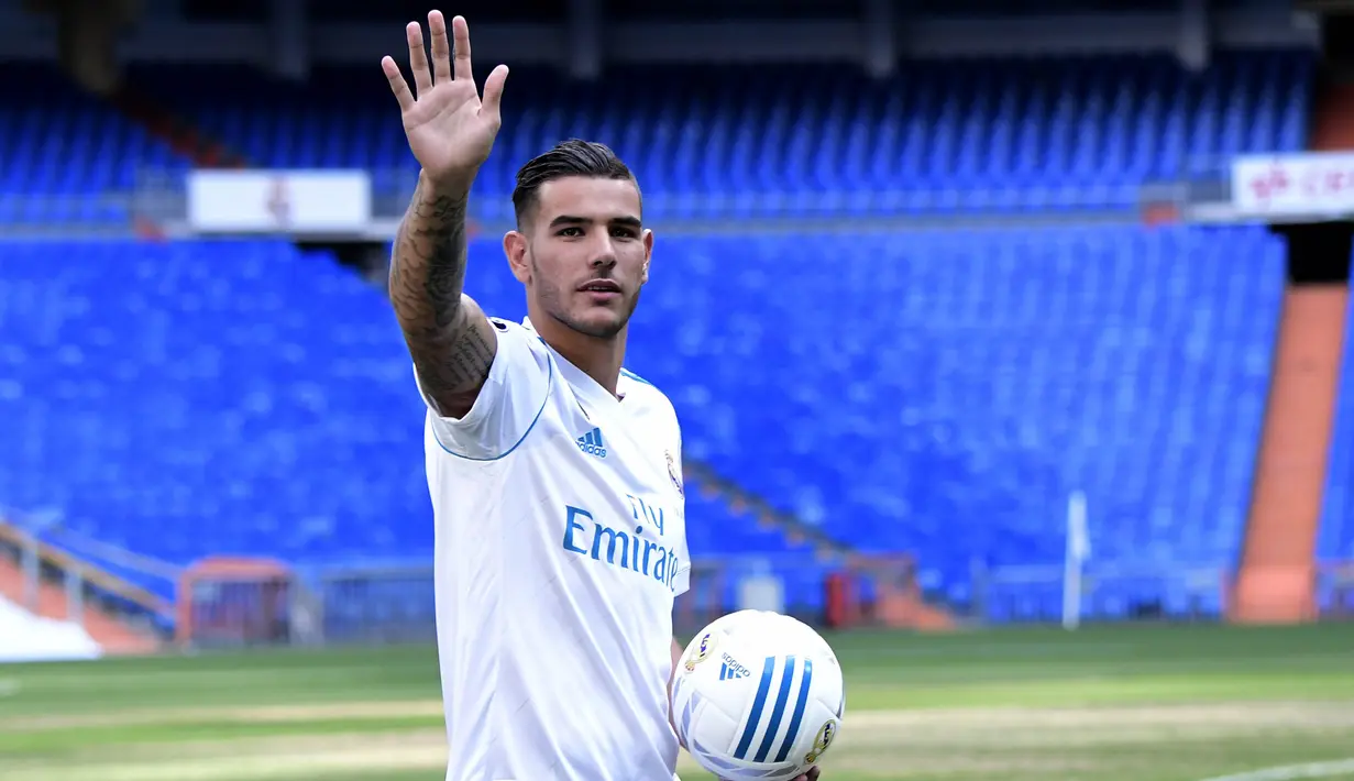 Pemain baru Real Madrid, Theo Hernandez, melambaikan tangan ke suporter saat baru diperkenalkan di Stadion Santiago Bernabeu, Madrid, Senin (10/7/2017). (AFP/Javier Soriano)
