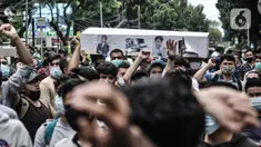 Pencari suaka membawa replika peti jenazah saat unjuk rasa di depan kantor UNHCR, Jakarta, Senin (14/12/2020). Mereka meminta agar proses perpindahan ke negara tujuan dipercepat setelah adanya tiga orang pengungsi yang bunuh diri dalam dua minggu terakhir karena depresi. (merdeka.com/Iqbal Nugroho)