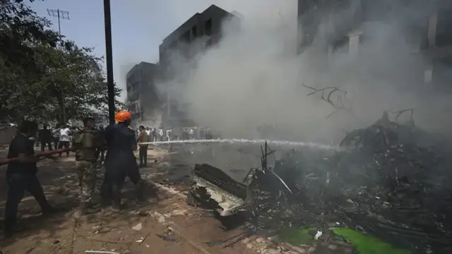 Petugas di lokasi pesawat Air India Jatuh di permukiman Ahmedabad, Kamis 12 Juni 2025. (AP/Ajit Solanki)