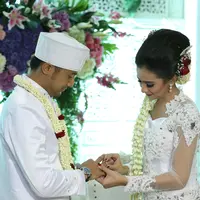 Sonya Fatmala memasangkan cincin ke suami tercintanya, Hengky Kurniawan. (Galih W. Satria/bintang.com)