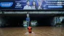 Petugas mengecek kondisi air yang membanjiri terowongan Dukuh Atas, Jakarta, Senin (11/12). Hujan lebat yang mengguyur ibu kota mengakibatkan genangan hingga satu meter di lokasi tersebut. (Liputan6.com/Faizal Fanani)