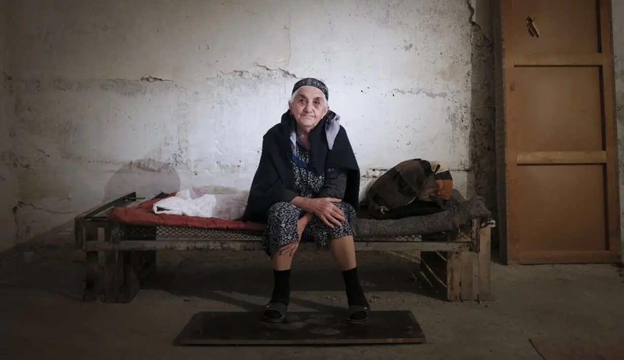Seorang wanita tua Armenia duduk dalam tempat penampungan untuk melindungi diri dari serangan bom di Stepanakert, Republik Nagorno-Karabakh, Azerbaijan, 27 September 2020. Armenia dan Azerbaijan saling menyalahkan karena melanjutkan serangan. (Karo Sahakyan/ArmGov/PAN Photo via AP)