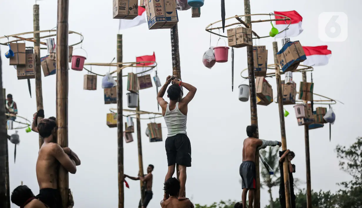 Beberapa peserta mengikuti lomba panjat pohon pinang di Pantai Festival Ancol, Jakarta, Rabu (17/8/2022). Sebanyak 45 pohon pinang siap dipanjat oleh pengunjung di Pantai Festival Ancol  untuk memeriahkan Hari Ulang Tahun (HUT) Ke-77 Republik Indonesia. (Liputan6.com/Faizal Fanani)