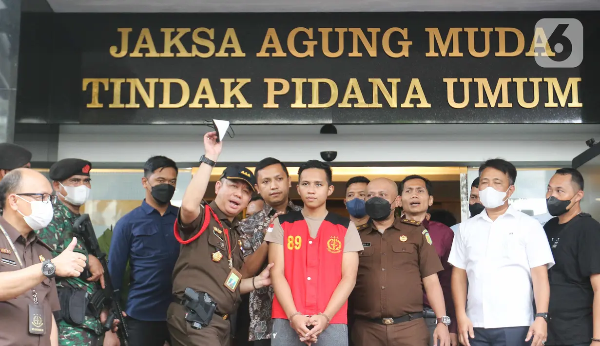 Tersangka kasus pembunuhan berencana Brigadir J, Richard Eliezer (tengah) ditunjukkan petugas saat saat proses pelimpahan berkas perkara tahap dua kasus di Gedung Kejaksaan Agung, Jakarta, Rabu (5/10/2022). Penyidik Bareskrim Polri menyerahkan 11 tersangka dan barang bukti kepada Kejaksaan Agung dalam pelimpahan tahap dua terkait kasus pembunuhan berencana Brigadir J dan obstruction of justice yang salah satunya menjerat mantan Kadiv Propam Ferdy Sambo. (Liputan6.com/Herman Zakharia)