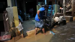 Warga Kampung Pulo, Kelurahan Kampung Melayu, Jatinegara, Jakarta, mulai melakukan aktivitas bersih-bersih menyusul surutnya air yang sempat merendam pemukiman mereka, Selasa, (17/11). (Liputan6.com/Gempur M Surya)