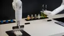 Samsung Bot Chef memotong tahu saat menunjukkan kemampuannya selama ajang  CES 2020 di Las Vegas, Nevada pada 8 Januari 2020. Samsung memamerkan robot koki canggih memiliki berbentuk lengan panjang yang bisa masak berbagai macam makanan. (AP/John Locher)