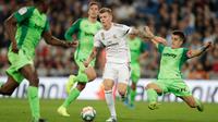 Gelandang Real Madrid, Toni Kroos  mencoba menghindari hadangan pemain Leganes pada pekan ke-11 La Liga 2019-2020 di Santiago Bernabeu,, Rabu (30/10/2019). Real Madrid tanpa ampun menghajar tamunya Leganes, 5-0. (AP/Bernat Armangue)