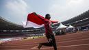 Pelari Indonesia, Tiarani Karisma, melakukan selebrasi usai meraih medali emas Asian Para Games cabang atletik nomor lari 100 meter T42 / T63 di SUGBK, Jakarta, Rabu (10/10/2018). (Bola.com/Vitalis Yogi Trisna)