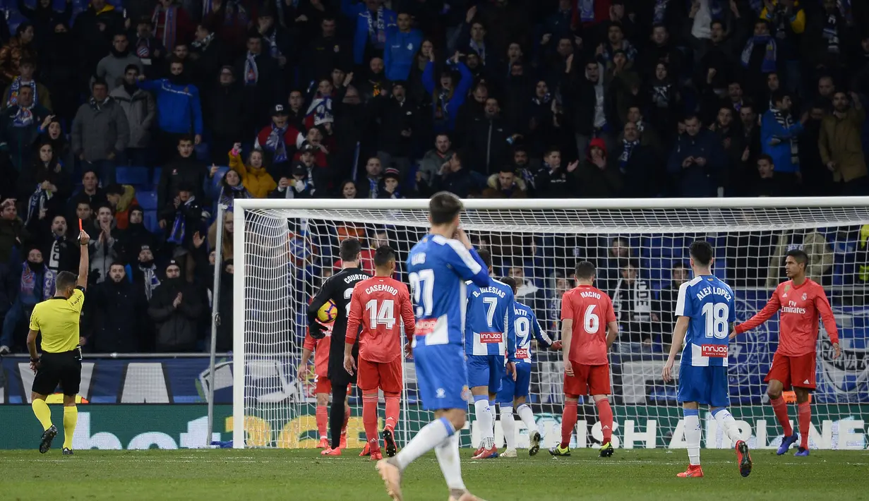 Kemenangan Real Madrid harus dibayar mahal dengan di kartu merahnya Raphael Varane pada laga lanjutan La Liga yang berlangsung di stadion Cornellà-El Prat, Espanyol, Senin (28/1). Real Madrid menang 4-2 atas Espanyol. (AFP/Josep Lago)