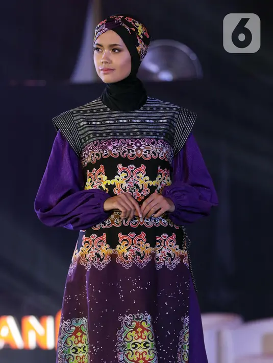 Seorang model berpose mengenakan busana rancangan Wignyo saat peragaan busana dalam gelaran Festival 6 2023 di Senayan Park, Jakarta, Minggu (9/7/2023). (Liputan6.com/Helmi Fithriansyah)