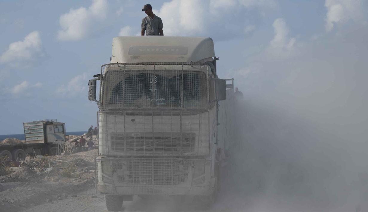 Sebelumnya, perbatasan Zikim ditutup sejak 12 September dan baru dibuka kembali pada pekan ini, sebagai bagian dari kesepakatan gencatan senjata antara Israel dan Hamas yang berlaku mulai 10 Oktober 2025. Tampak dalam foto, truk-truk yang mengangkut bantuan kemanusiaan melintasi Kota Gaza setelah masuk dari Israel melalui pos perbatasan Zikim di bagian utara Jalur Gaza, Kamis 13 November 2025. (AP Photo/Jehad Alshrafi)