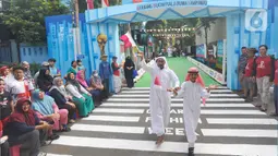 Warga menggelar fashion show menjelang Piala Dunia 2022 Qatar di Perum Depok Maharaja Blok M1 Cluster Cemara, Rangkapan Jaya, Depok, Minggu (20/11/2022). Berbagai pernak-pernik bernuansa Piala Dunia terlihat bertebaran di acara fashion show tersebut. (merdeka.com/Arie Basuki)