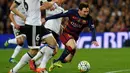 Penyerang Barcelona, Lionel Messi berusaha membawa bola melewati para pemain Valencia di pertandingan liga Spanyol di Camp Nou stadium (18/4). Valencia menang atas Barcelona dengan skor 2-1. (AFP PHOTO/GENE Lluis)