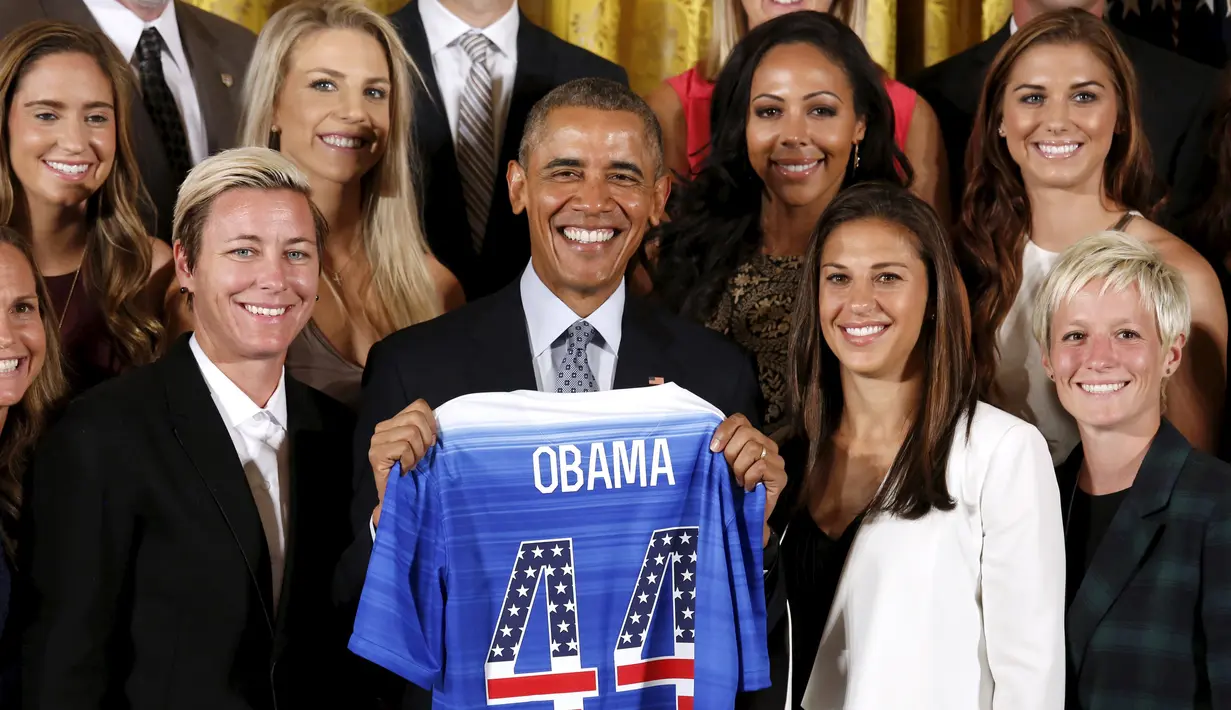 Presiden AS Barack Obama berpose dengan jersey kehormatan saat merayakan kemenangan tim sepakbola putri Amerika pada turnamen Piala Dunia Sepakbola Putri 2015 di Gedung Putih, Washington, Selasa (27/10). (REUTERS/Kevin Lamarque)