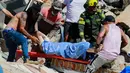 Warga dan polisi membawa seorang korban selamat yang ditarik dari reruntuhan setelah gempa bumi melanda Pereira, Kolombia, Senin, 10 Agustus 2026. (Foto AP/Miguel Angel Lopez)