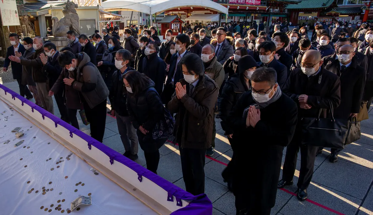 Orang-orang mengunjungi Kuil Kanda Myojin untuk berdoa Tahun Baru di Tokyo pada 4 Januari 2023.  Karyawan perusahaan, banyak yang mengenakan jas, berbondong-bondong ke kuil Kanda Myojin di pusat kota Tokyo untuk mempersembahkan doa tradisional untuk "bisnis yang baik" pada 4 Januari, hari kerja pertama tahun ini. (AFP/Kazuhiro Nogi)