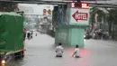 Dua orang anak bermain banjir yang merendam Jalan Gunung Sahari, Pademangan, Jakarta Pusat, Selasa (21/2). Hujan yang turun sejak dini hari menyebabkan sejumlah ruas jalan terimbas banjir hingga tak bisa dilalui kendaraan (Liputan6.com/Faizal Fanani)