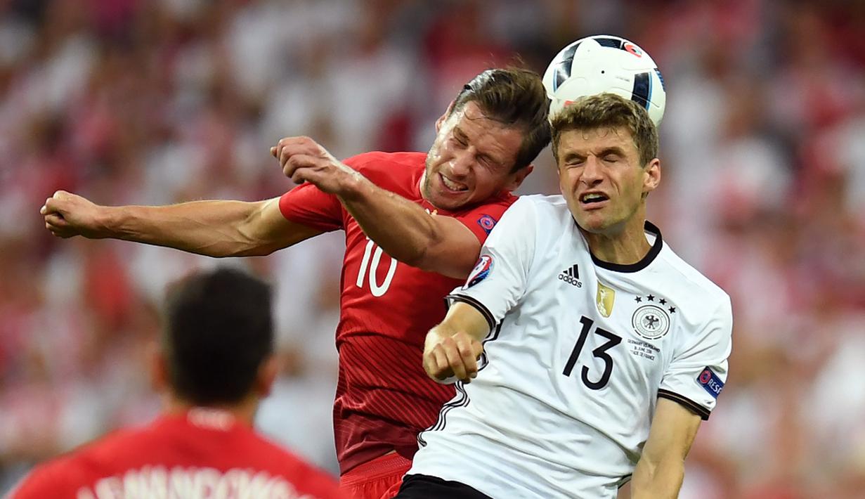 Pemain Jerman, Thomas Muller, duel dengan pemain Polandia, Grzegorz Krychowiak, pada laga kedua Grup C Piala Eropa 2016 di Stade de France, Jumat (17/6/2016) dini hari WIB. (AFP/Patrik Stollarz)