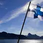 Bendera Finlandia yang berada di kapal pemecah es Finlandia MSV Nordica saat tiba di Nuuk, Greenland (29/7). Bersama kapal pemecah es MSV Nordica mereka mengarungi laut sejauh lebih 10.000 kilometer selama 24 hari. (AP Photo/David Goldman)