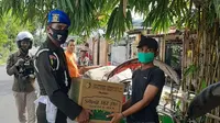Kiper Arema FC, Teguh Amiruddin, kembali bertugas sebagai anggota TNI saat memberikan bantuan kepada masyarakat di Surabaya. (Bola.com/Iwan Setiawan)