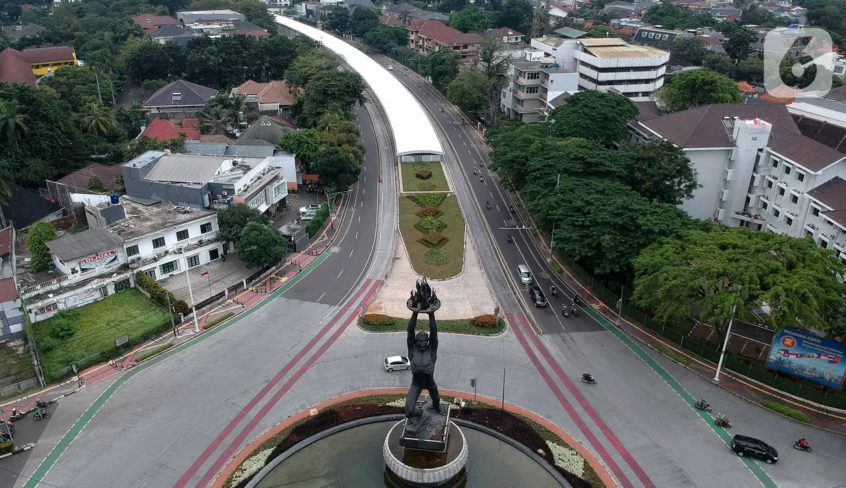 Foto aerial kendaraan melintas di Jalan Jenderal Sudirman, Jakarta, Selasa (24/3/2020). Sejumlah ruas jalan utama ibu kota lebih lengang dibandingkan hari biasa karena sebagian perusahaan telah menerapkan bekerja dari rumah guna menekan penyebaran COVID-19. (Liputan6.com/Faizal Fanani)