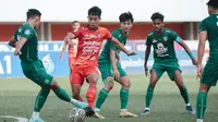 Gelandang muda Bali United I Made Tito Wiratama berusaha lepas dari penjagaan bek Persebaya Surabaya Rizky Ridho dalam lanjutan pekan ke-25 BRI Liga 1 2022/2023 di Stadion Maguwoharjo, Sleman. (Bola.com/Maheswara Putra)