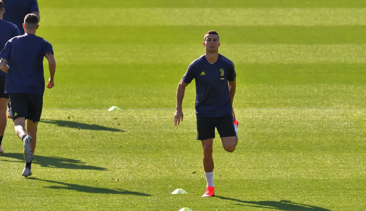 Cristiano Ronaldo melakukan pemanasan saat latihan di pusat pelatihan Juventus Continassa di Turin (22/10). Juventus akan bertanding melawan Manchester United pada lanjutan grup H Liga Champions di Old Trafford. (AFP Photo/Marco Bertorello)