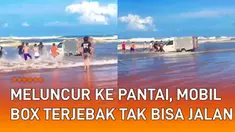 Sebuah mobil box terjebak di arus ombak pantai mengundang perhatian