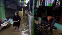 Aktivitas warga saat banjir di Jati Padang, Jakarta Selatan, Kamis (30/11). Banjir yang terjadi tersebut akibat tanggul darurat di Kali Pulo jebol karena genangan air yang cukup deras dan membanjiri permukiman sekitar. (Liputan6.com/Johan Tallo)