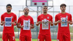 Timnas Iran juga menampilkan foto-foto anak-anak yang menjadi korban perang akibat serangan udara Amerika Serikat-Israel saat laga uji coba melawan Kosta Rika di Stadion Corendon Airlines Park pada Selasa 31 Maret 2025. (AP Photo/Riza Ozel)